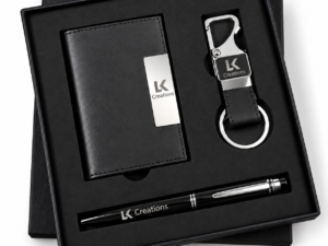 Personalized corporate gift set with notebook, pen, and keychain in a branded presentation box