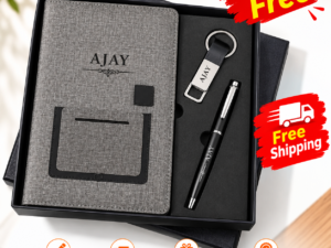 Personalized corporate gift set with gray diary, pen, and keychain arranged together